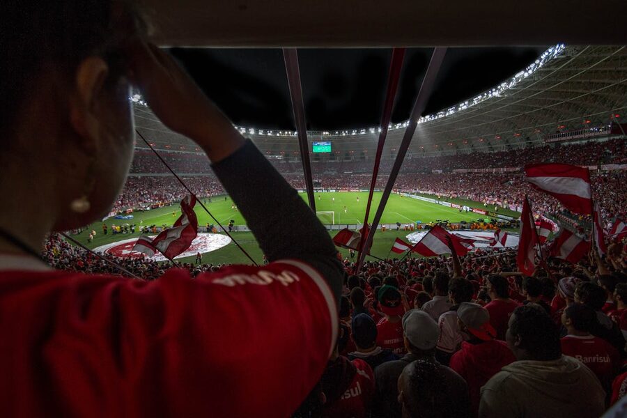 Football supporters watching a live match at a packed stadium