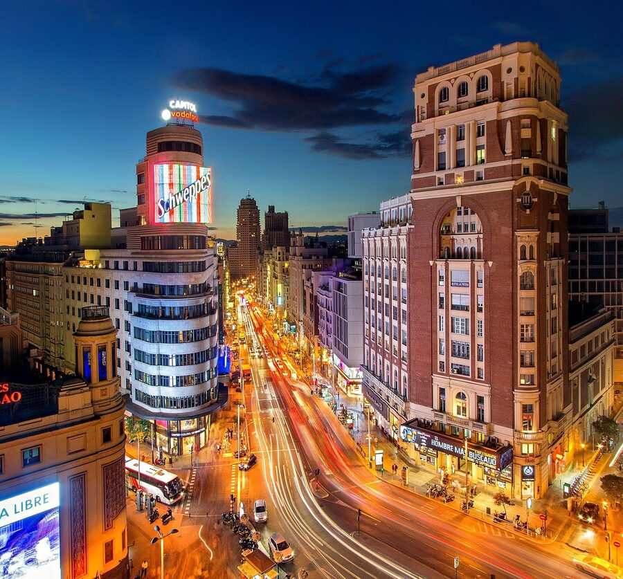 Gran Via Madrid at dusk with illuminated buildings