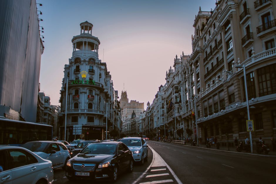 Evening traffic and city lights on Gran Via in Madrid with illuminated historic buildings
