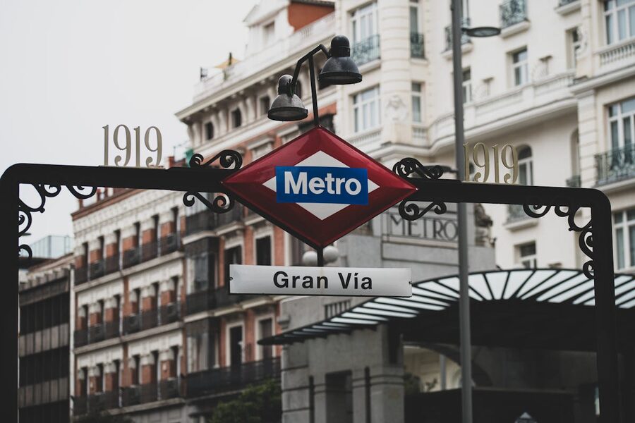 Classic view of Gran Via Metro entrance surrounded by historic architecture in Madrid