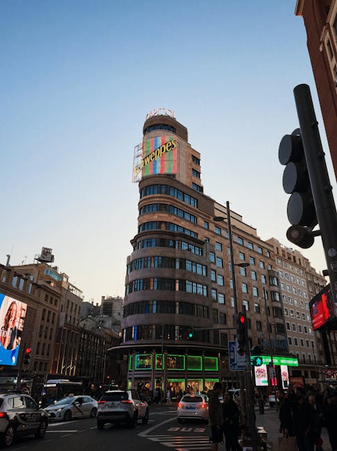 The Schweppes neon sign on the Capitol building on Gran Via in Madrid at sunset