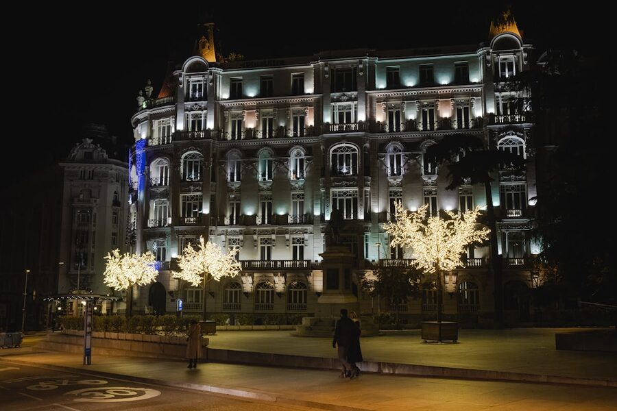 A historic building facade illuminated at night in Madrid