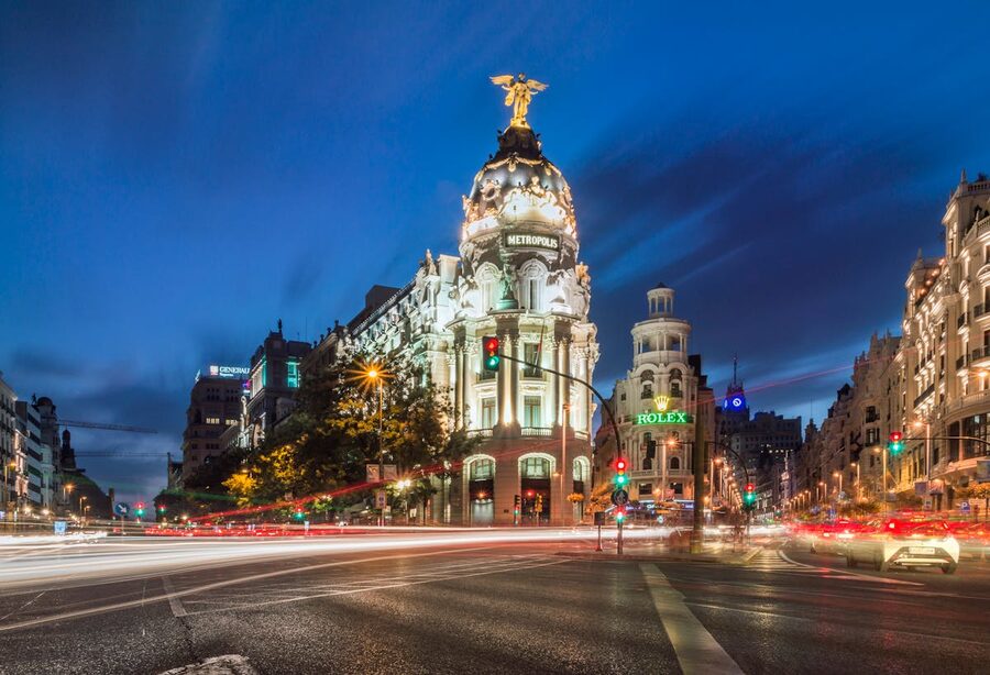 The Metropolis building in Madrid at night with car light trails