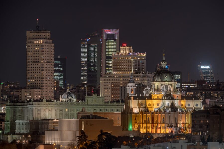 Illuminated Madrid cityscape at night showing iconic buildings