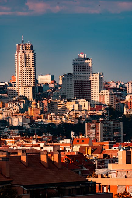 Madrid skyline at golden hour with the Torrespana tower and distant mountains