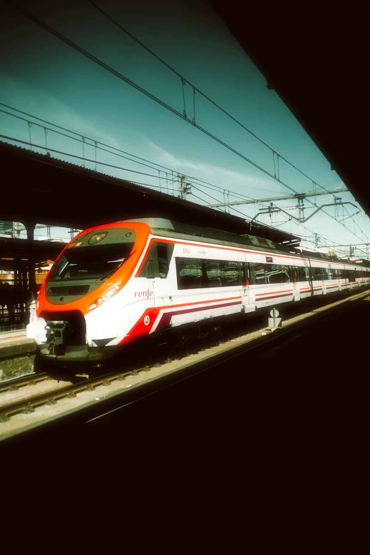A modern Spanish high-speed train at a station platform
