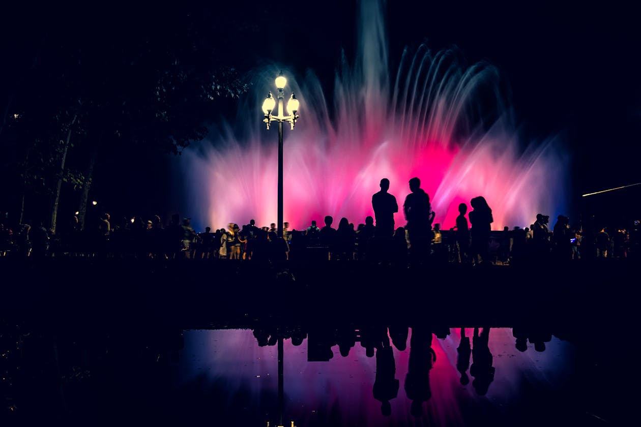 Crowd watching the colourful Magic Fountain water display at night