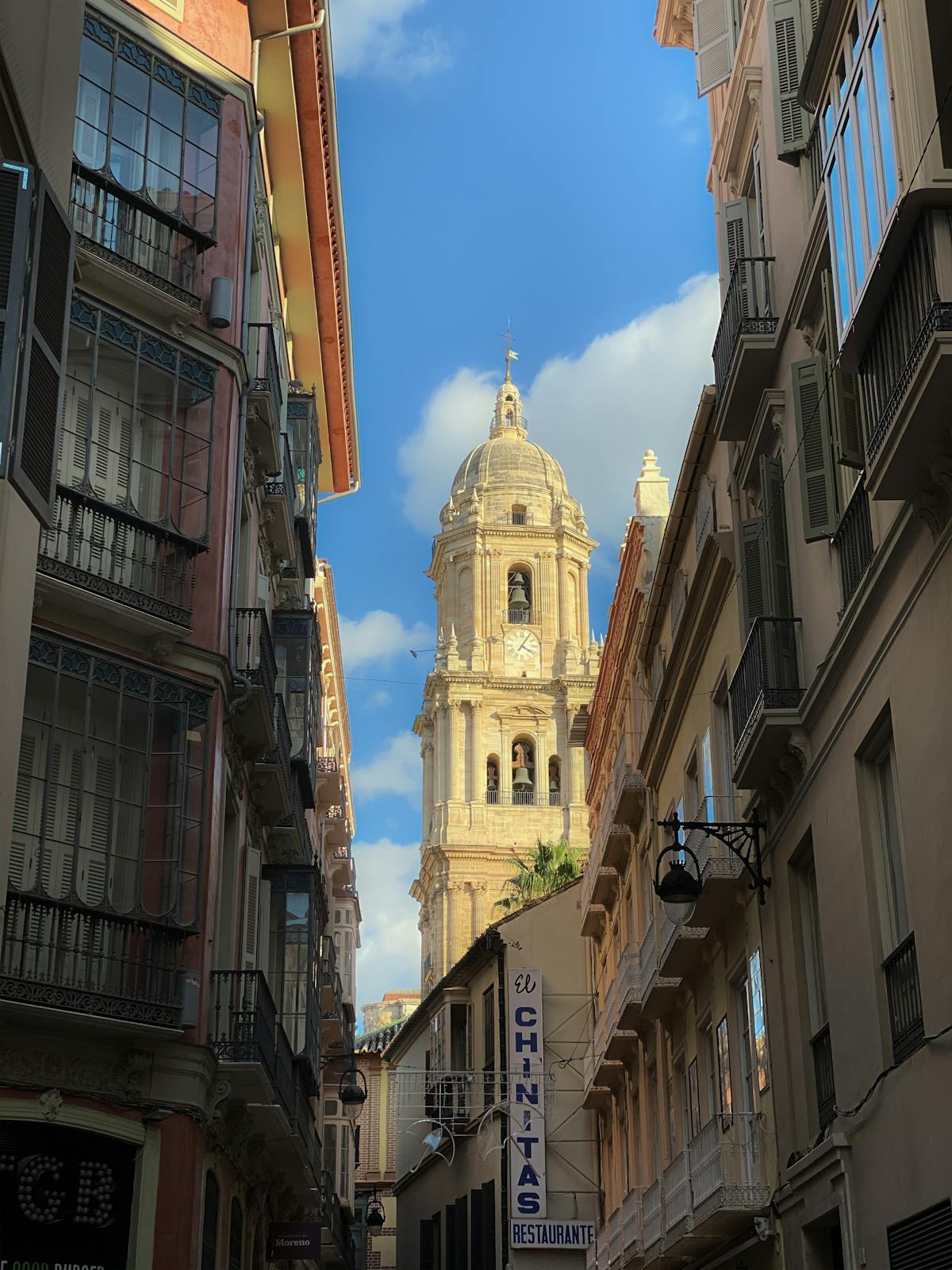 Malaga Cathedral tower viewed through narrow old town streets