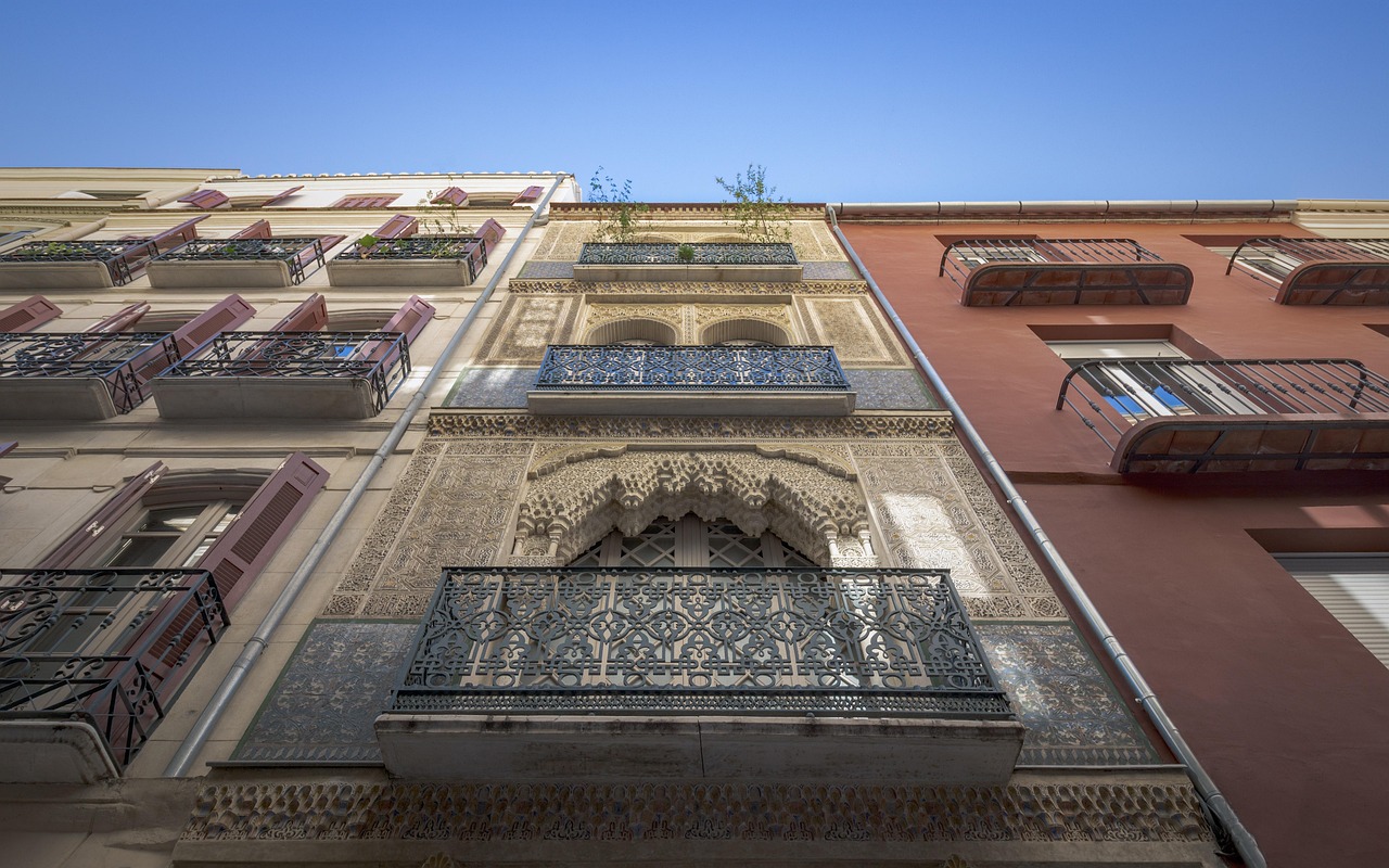 Colorful building facades along a narrow street in the old city center of Malaga Spain