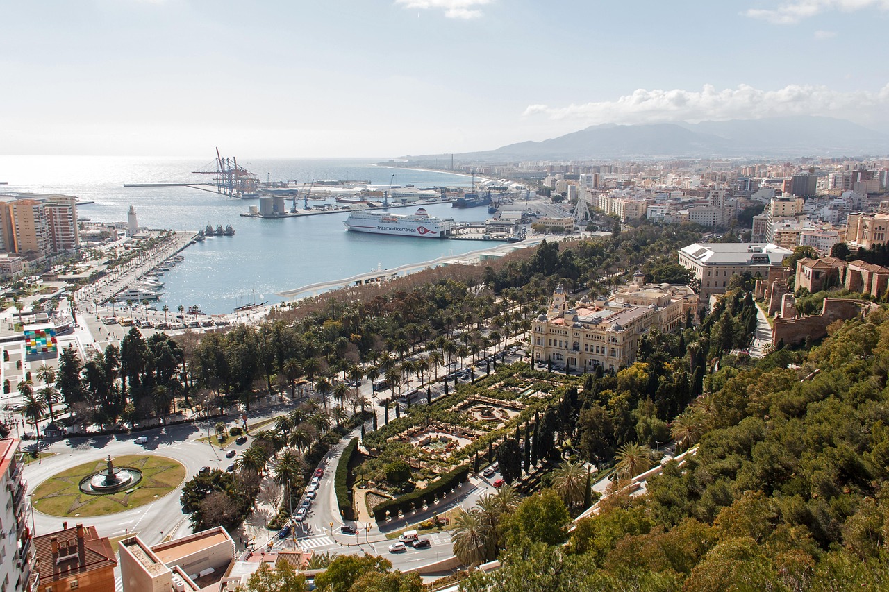 The ancient Roman Theatre ruins at the foot of the Alcazaba fortress in Malaga with palm trees and Mediterranean scenery