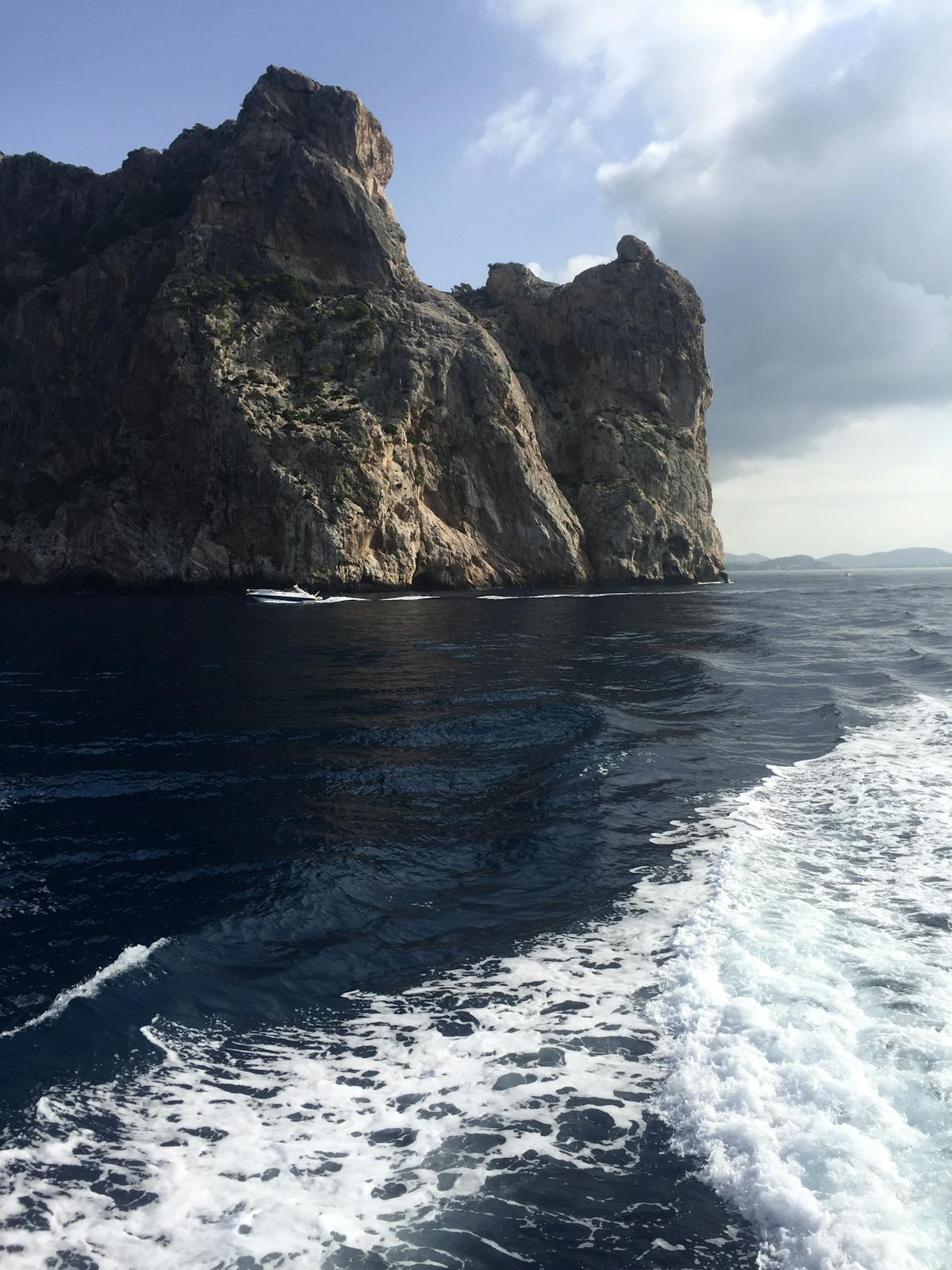 Dramatic limestone cliffs of Mallorca coast viewed from a boat on the Mediterranean Sea