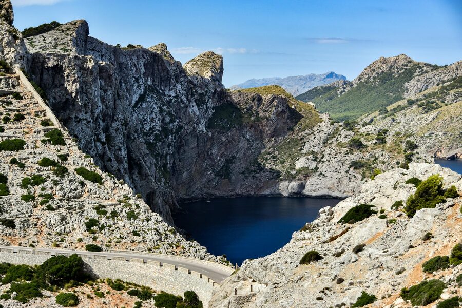 Winding coastal road along steep Tramuntana cliffs in Mallorca