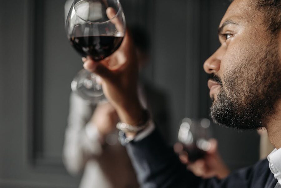 A man tasting a glass of port wine
