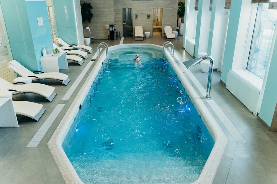 Indoor spa pool with loungers and natural light