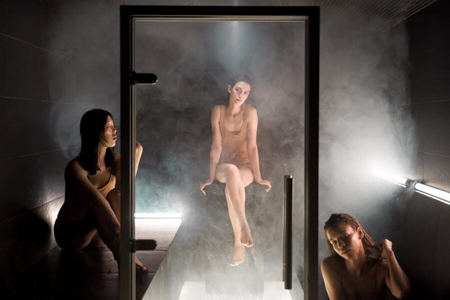 Women relaxing in dimly lit sauna