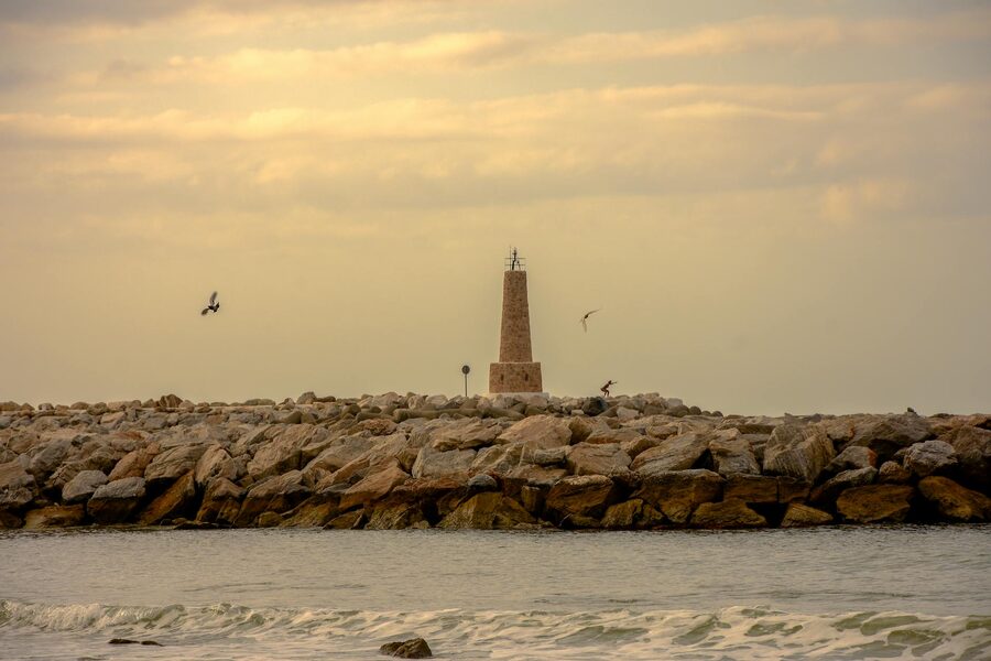 Lighthouse perched on the rocky coastline of Marbella Spain at dawn