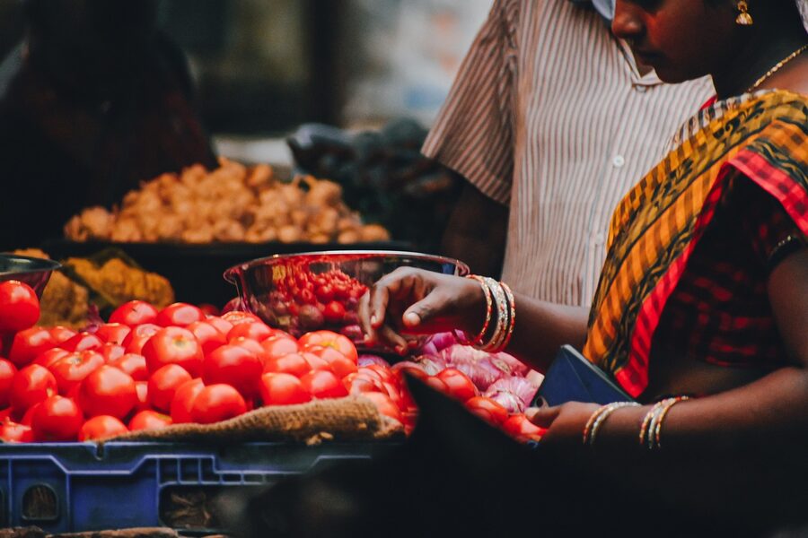 Colorful fresh vegetables and fruits displayed at an outdoor farmers market stall