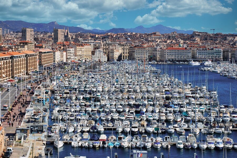 Sailing boats at Marseille Old Port with Notre-Dame de la Garde basilica on the hilltop