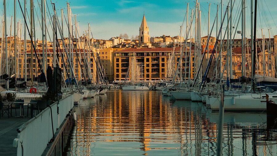 Golden sunrise over Marseille Old Port with boats and morning calm waters
