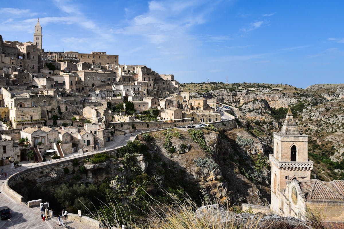 A shadowy narrow alley between ancient stone buildings in Matera