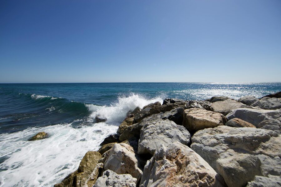 Rocky Mediterranean coastline with clear water under blue sky
