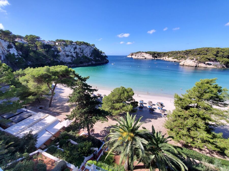 Aerial view of Cala Galdana beach and surrounding pine forest in Menorca