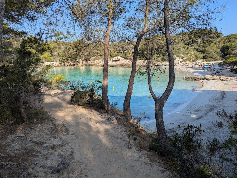 Crystal clear turquoise water at Cala Mitjana cove in Menorca