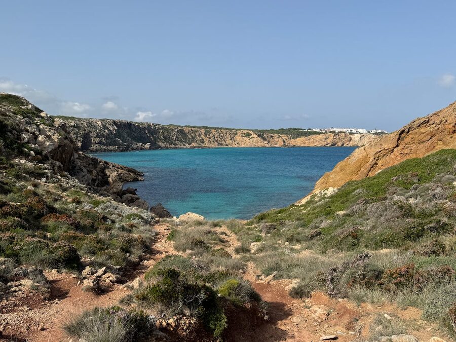 Rocky cliffs and turquoise sea at Cala Morell in Menorca