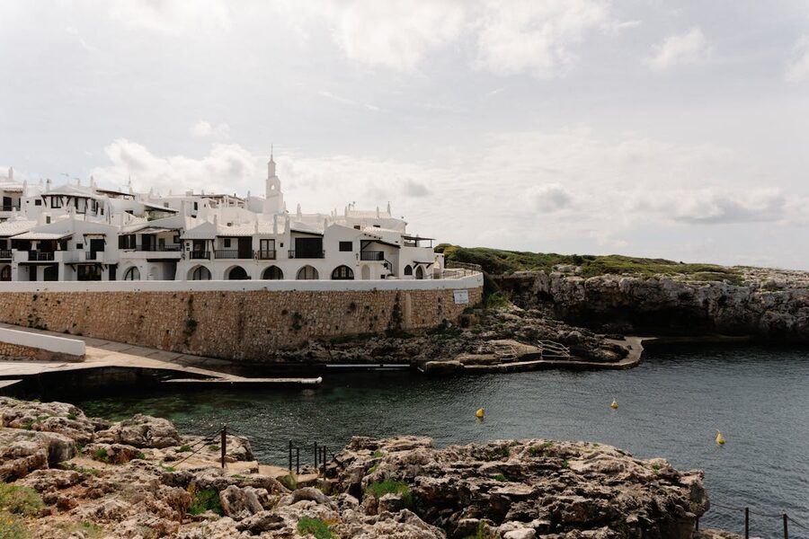 White buildings along the rocky coast of Ciutadella de Menorca