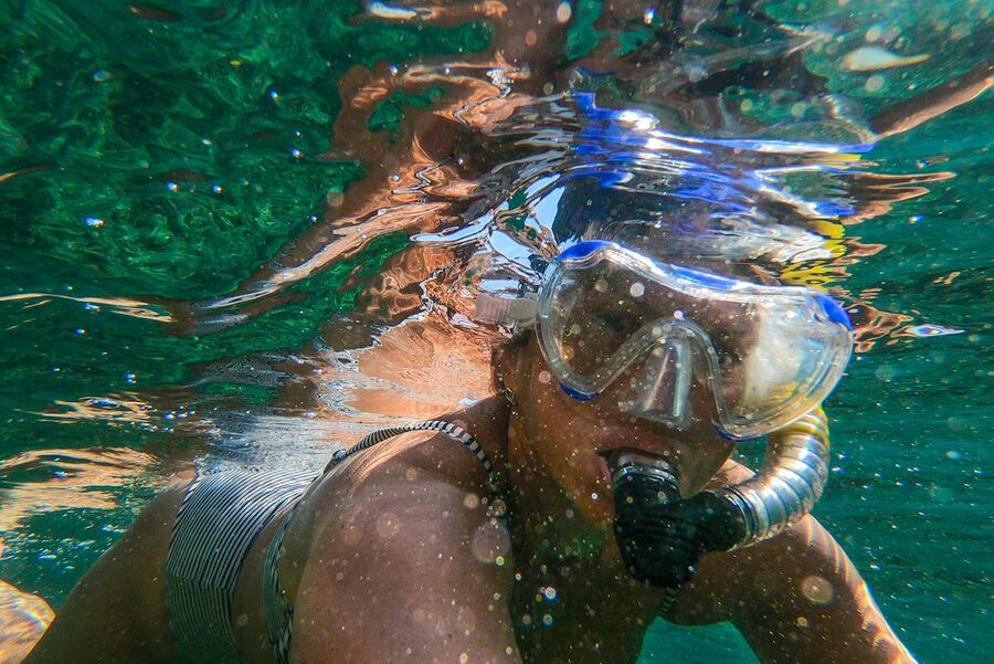 Woman snorkeling in clear coastal waters in Spain