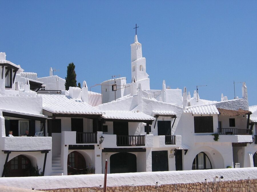 Traditional white village with church tower in Menorca