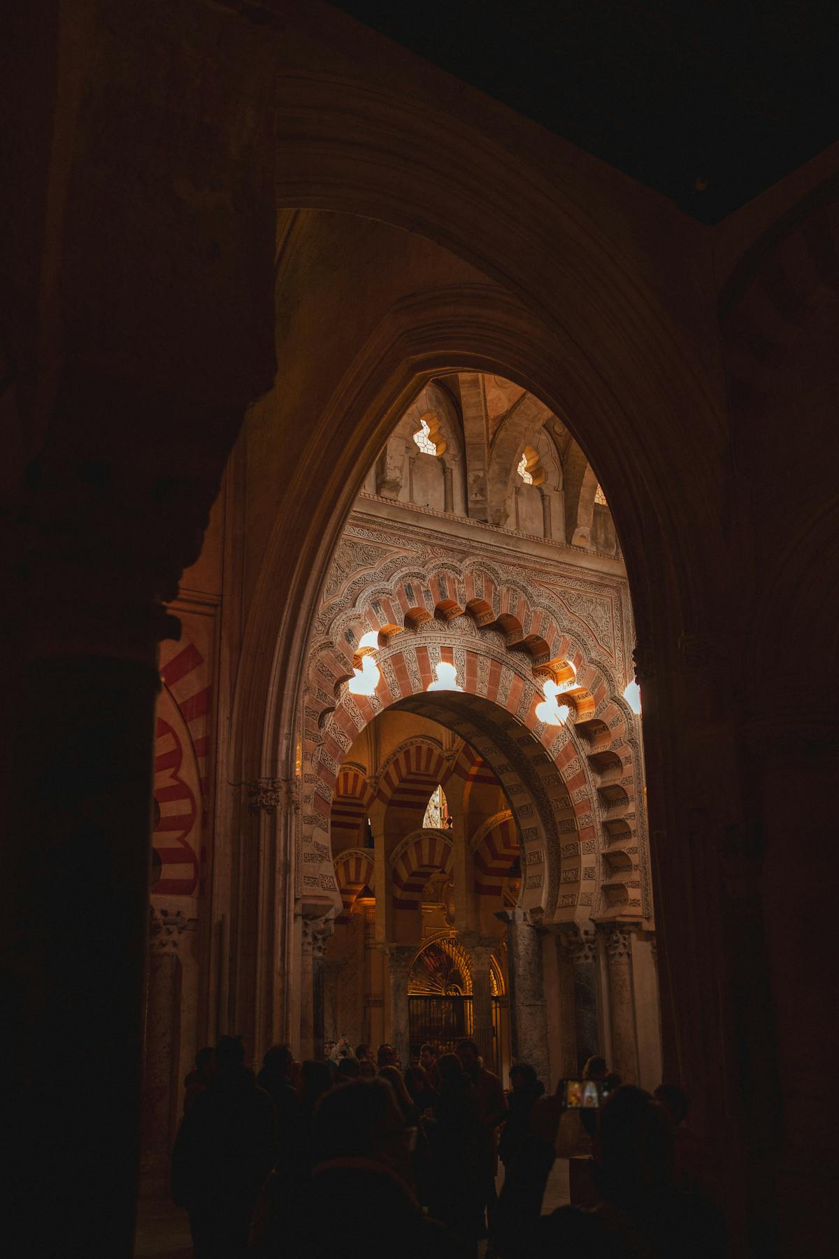 Dramatic perspective of the red and white horseshoe arches inside the Mezquita