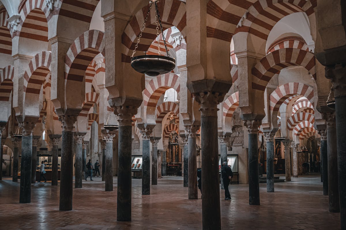 Hundreds of columns supporting red and white arches in the Mosque-Cathedral prayer hall