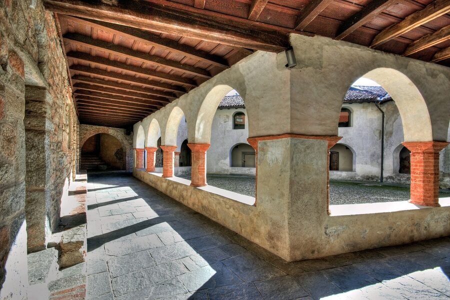 Italian cloister with stone columns and arched walkway in Lombardy