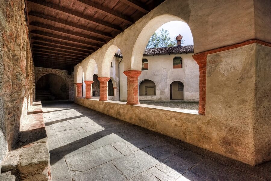 Gothic cloister walkway with stone columns at an Italian monastery