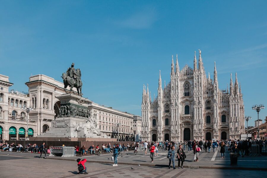 Milan Piazza del Duomo with people walking in the afternoon light