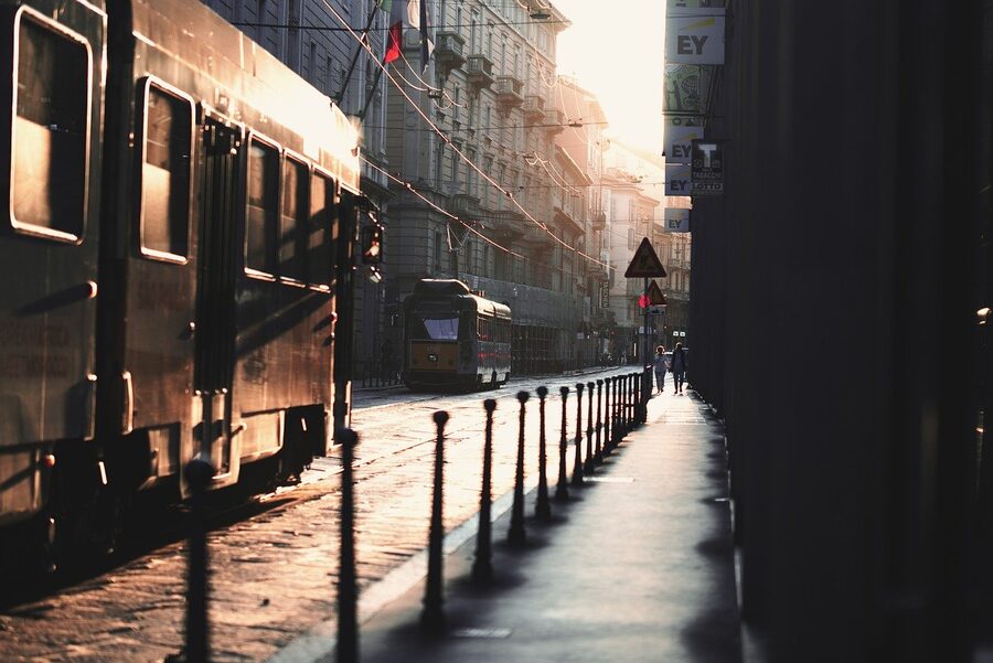 Milan tram on city streets with historic buildings in the background