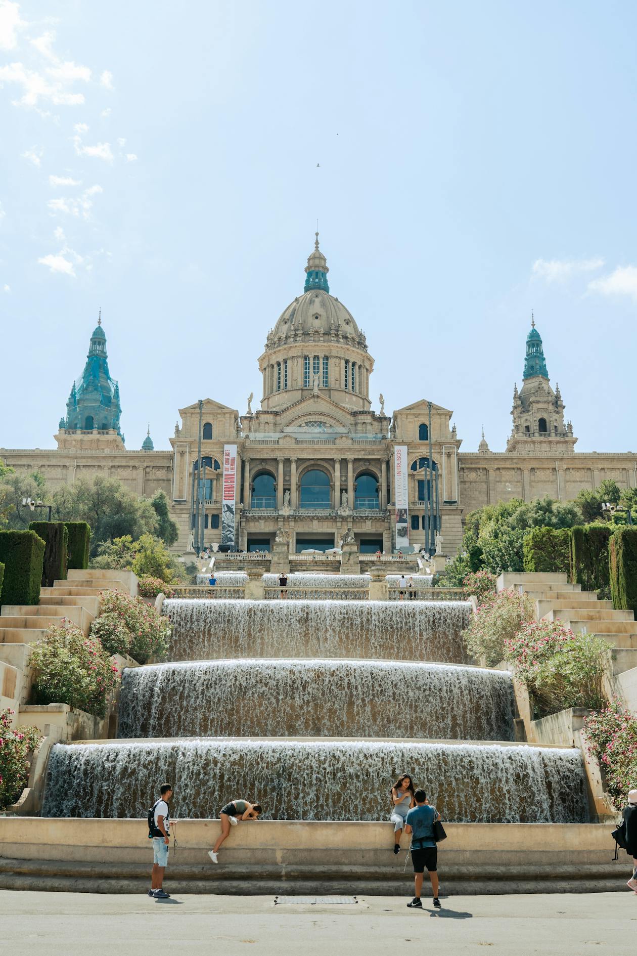 National Art Museum of Catalonia with cascading fountains under clear blue skies