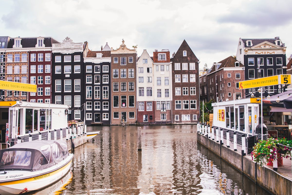 Amsterdam canal with historic homes and colorful reflections in the water