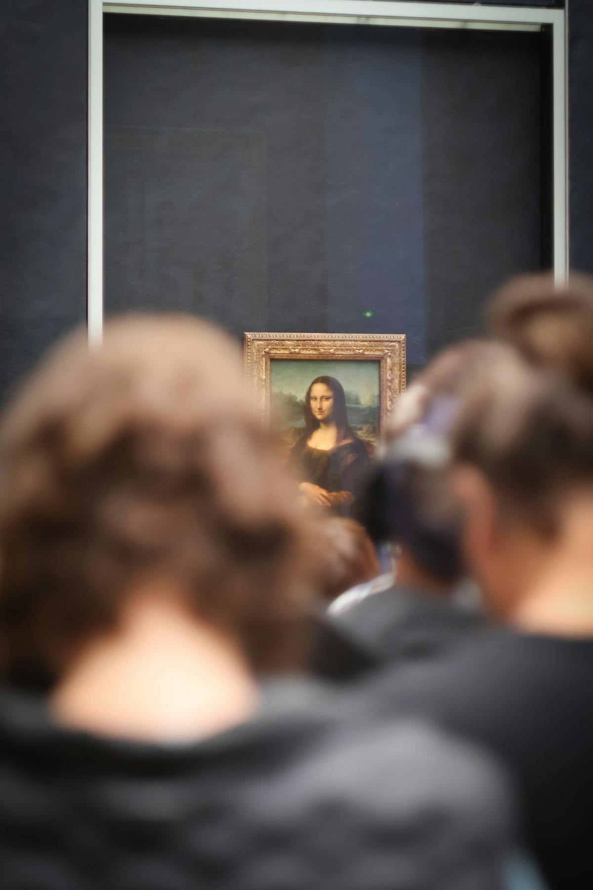 Tourists viewing and photographing the Mona Lisa at the Louvre