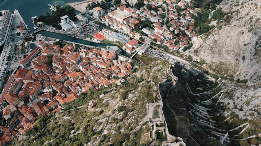 Kotor fortress walls and red roofs aerial