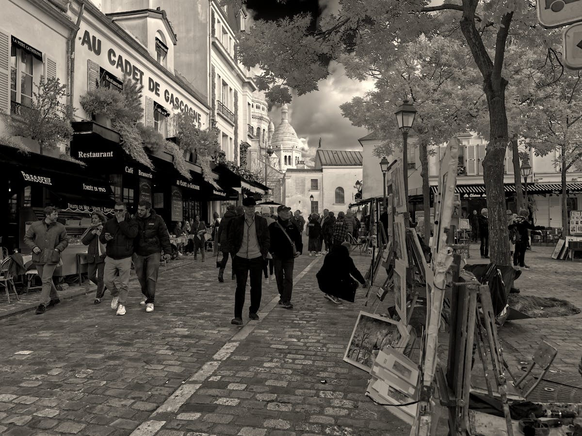 Street scene in Montmartre with Sacre-Coeur visible in the background