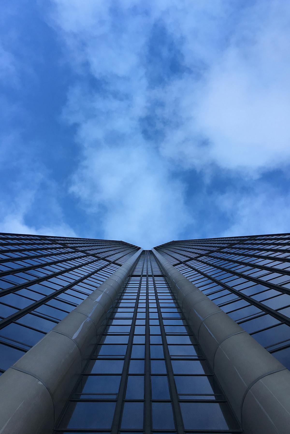 Looking up at the Montparnasse Tower from its base as it rises into the sky