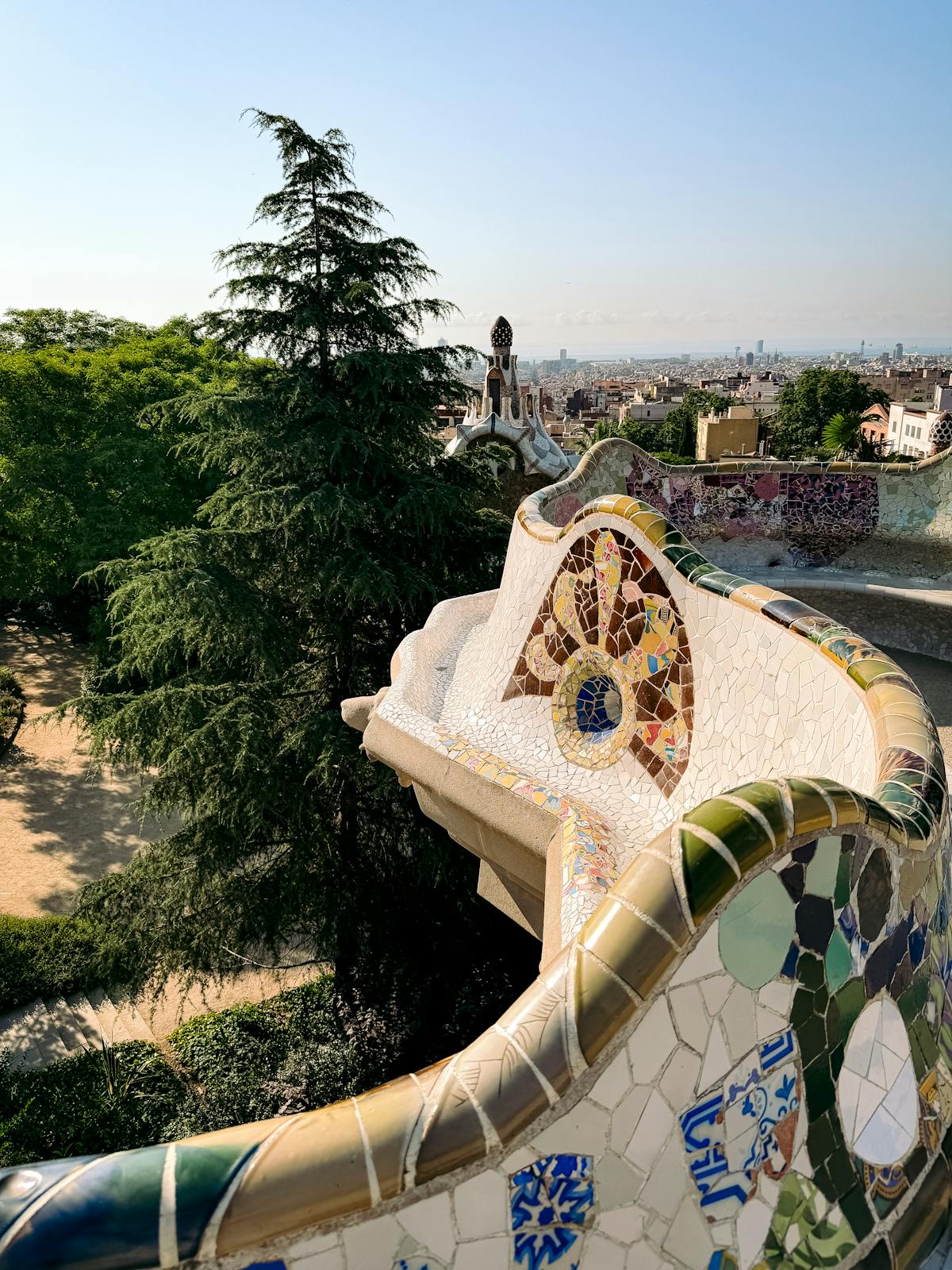 The winding mosaic bench at Park Guell with panoramic views of Barcelona