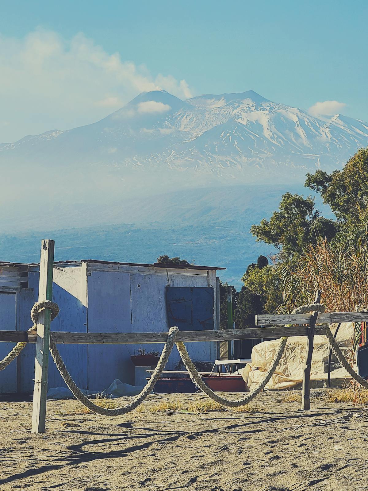 View of Mount Etna rising above the coastline as seen from Naxos beach