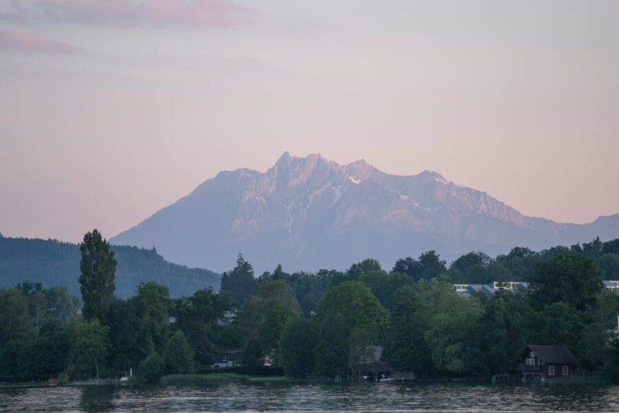 Mount Pilatus at sunset with greenery and water
