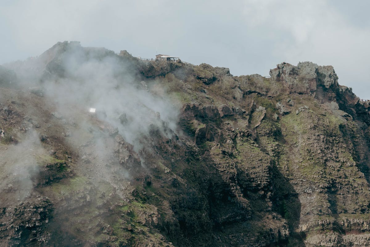 View of Mount Vesuvius crater with rugged terrain and clouds