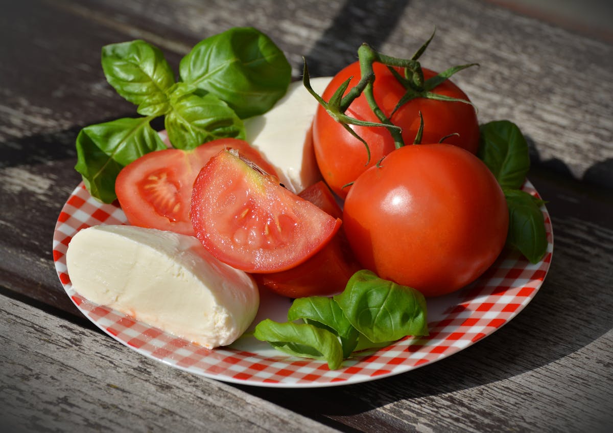Fresh mozzarella cheese with ripe tomatoes and basil leaves