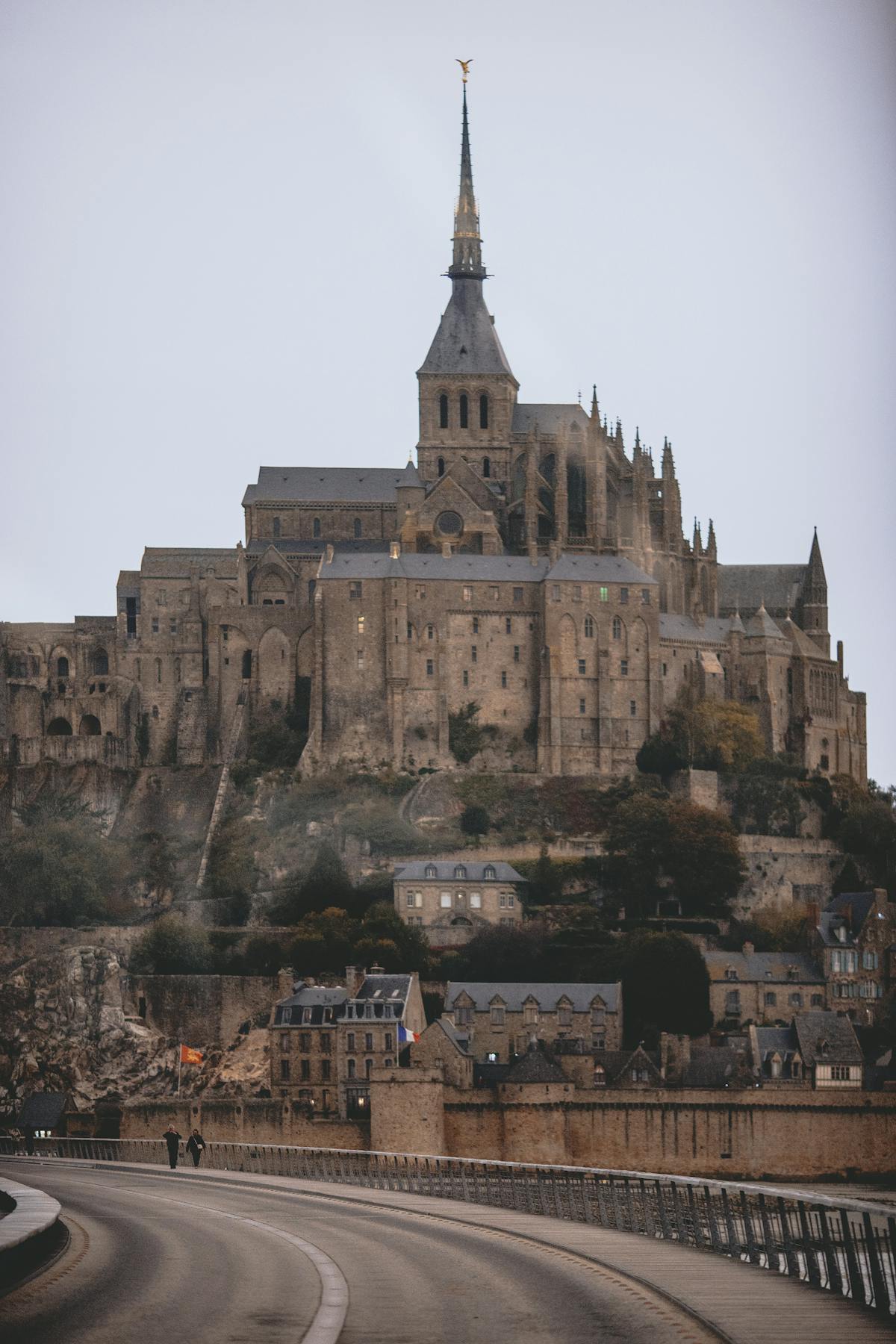 Gothic architecture of Mont Saint-Michel against stormy skies