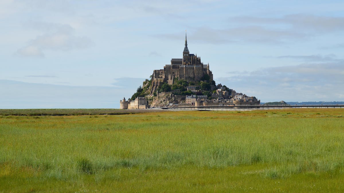 The tidal island of Mont Saint-Michel across flat Normandy marshland